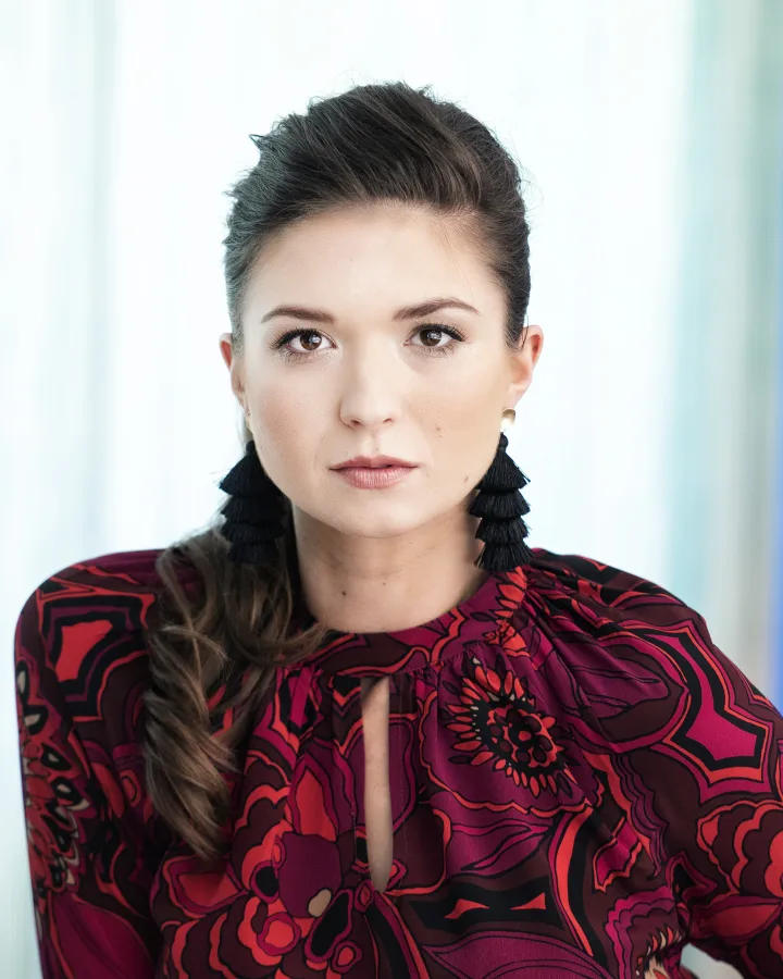 Hair worn sleek at the crown with a loose braid over the shoulder