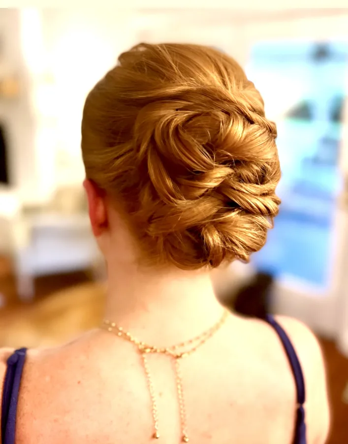 A twisted updo pinned low at the nape, photographed from behind